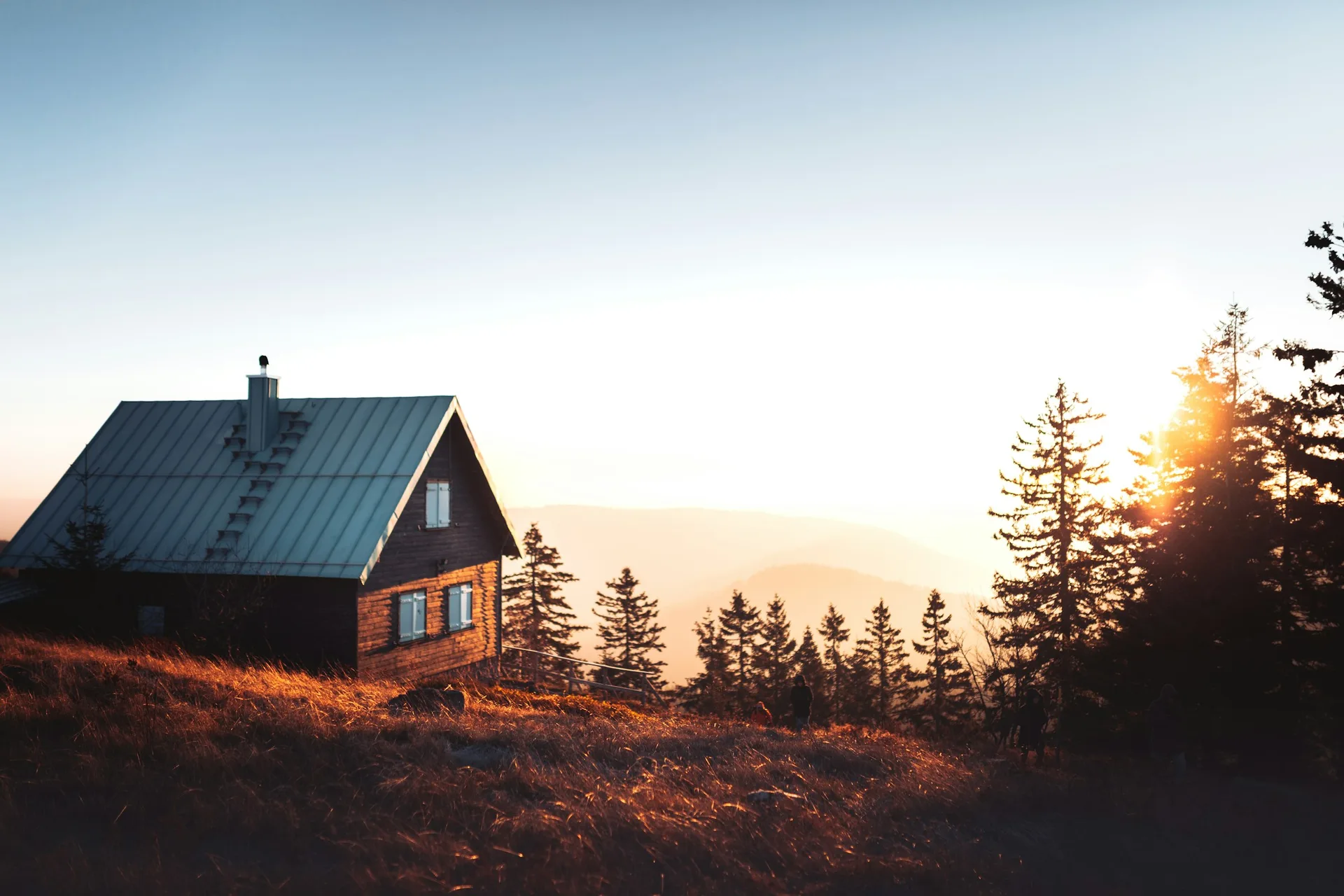 A Apex-built standing seam roof catching the last light over the ridge