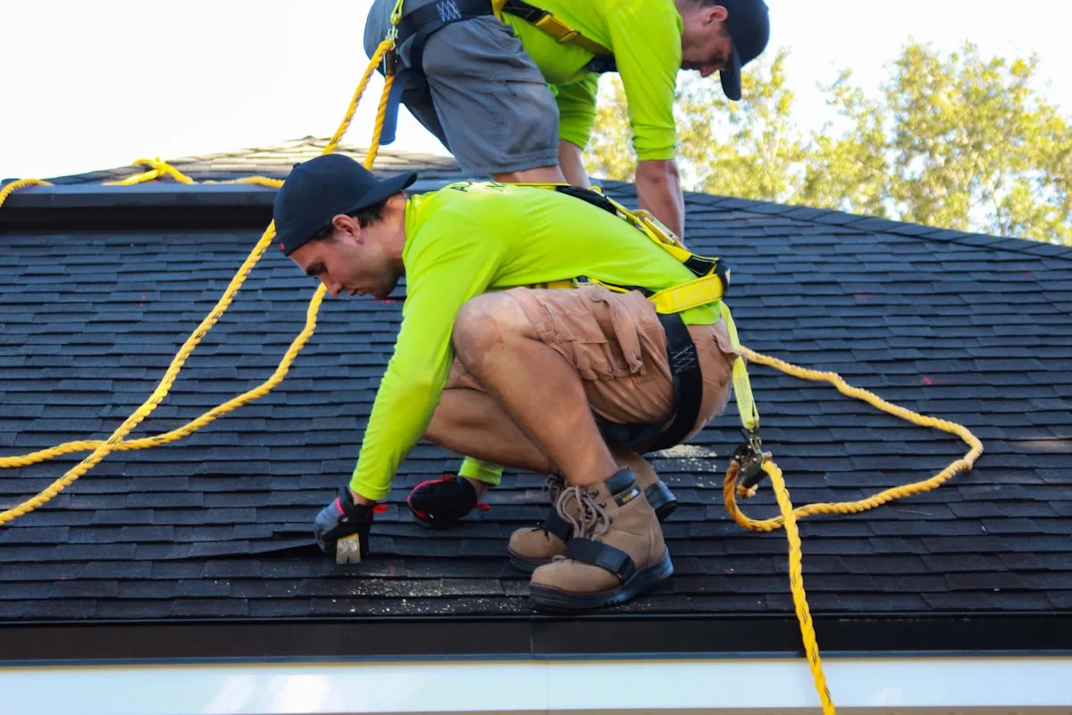 An Apex crew installing architectural shingles on a steep roof