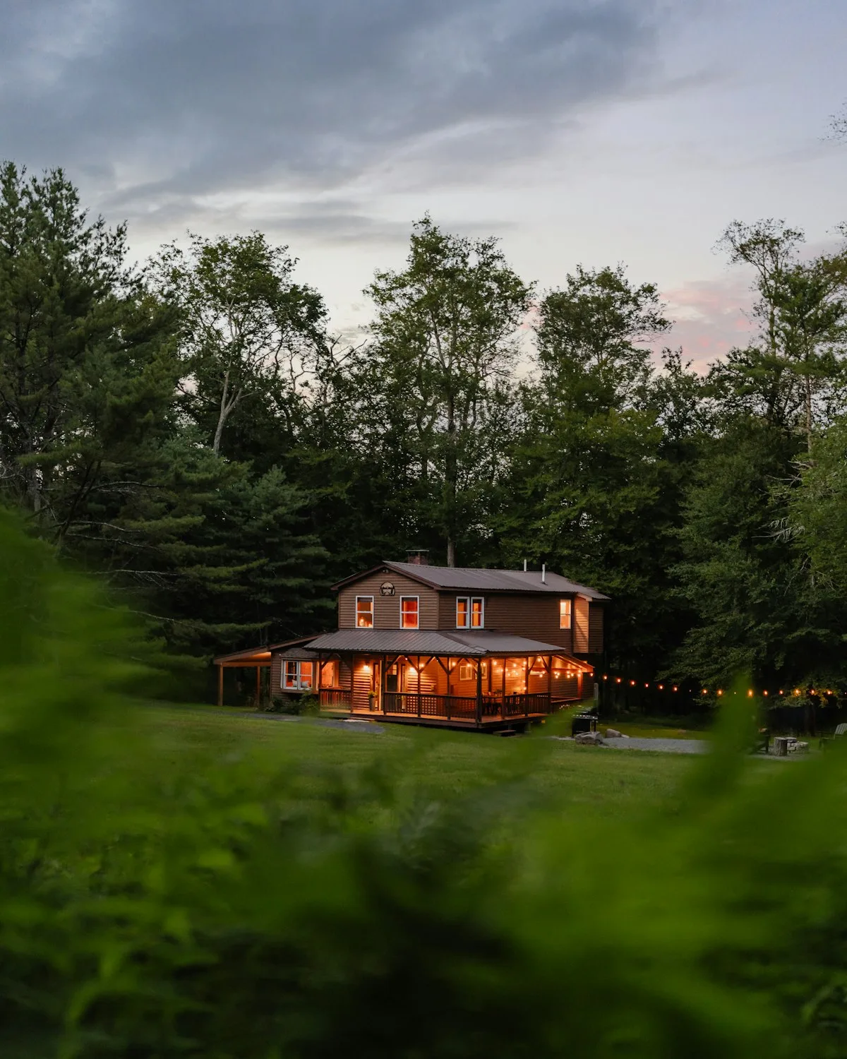 A Hill Country home lit up in the evening under a new roof