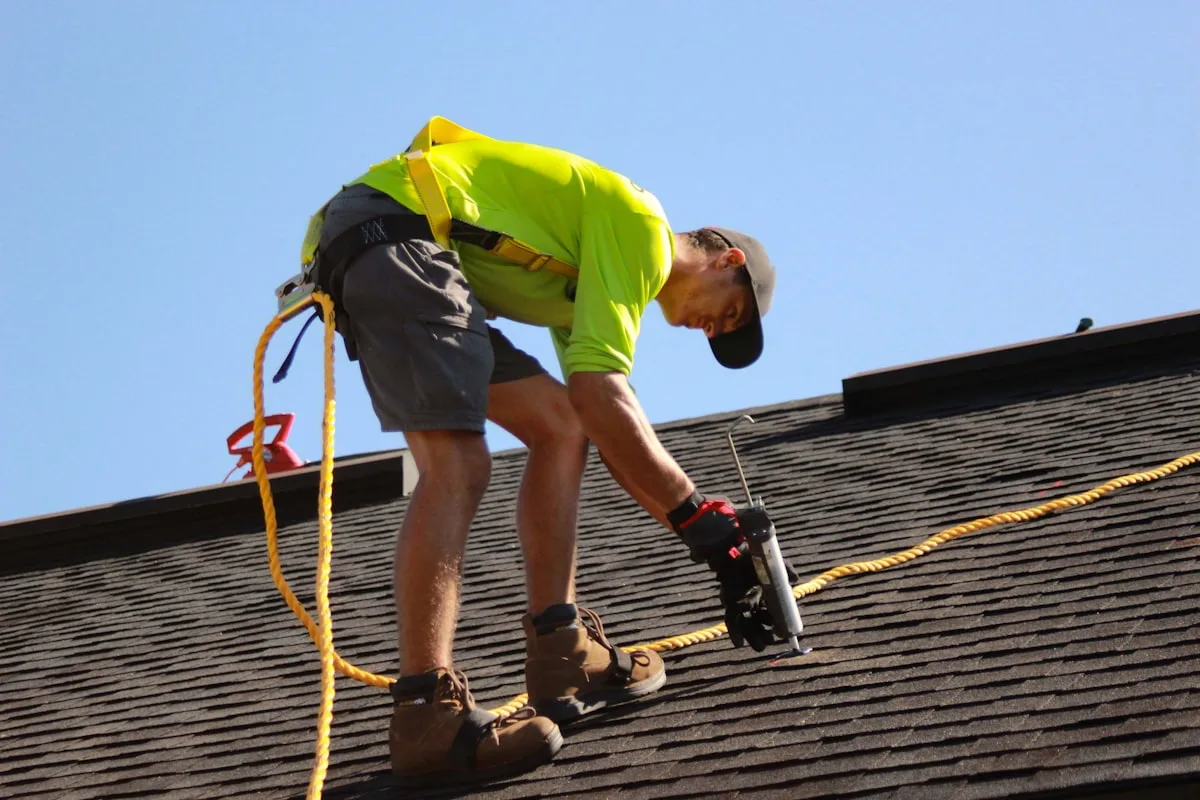 Sam Calloway fastening shingles on a steep pitch
