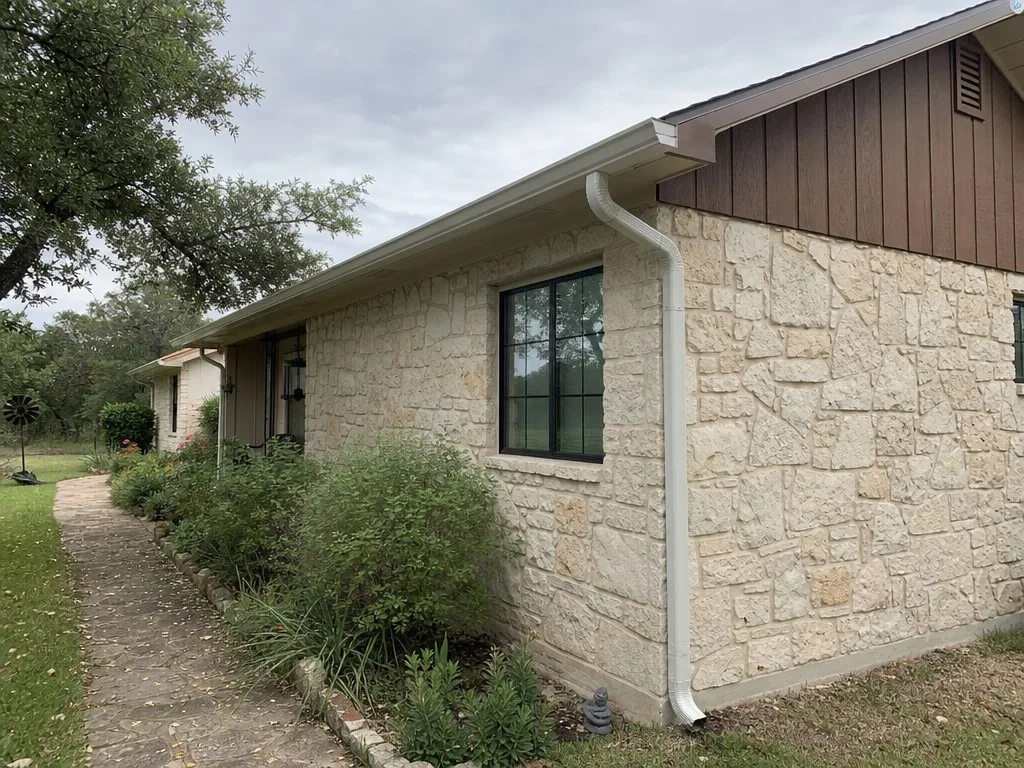 New gutter and downspout hung on clean fascia